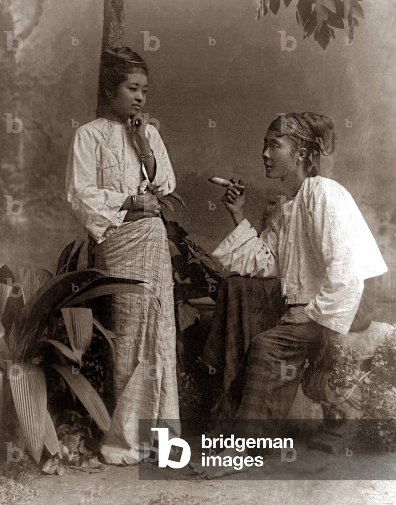 Burma / Myanmar: A Bamar couple, the man smoking a cheroot. Late 19th century