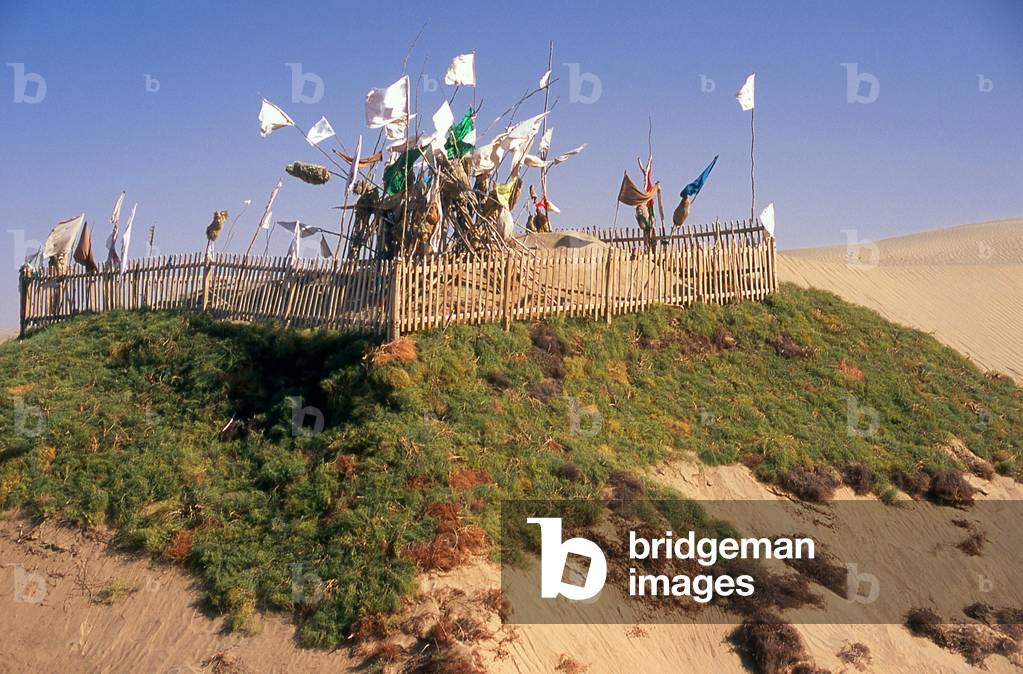 China: A tomb in the sand dunes near the Imam Asim Mazar (shrine) in the desert near Khotan, Xinjiang Province