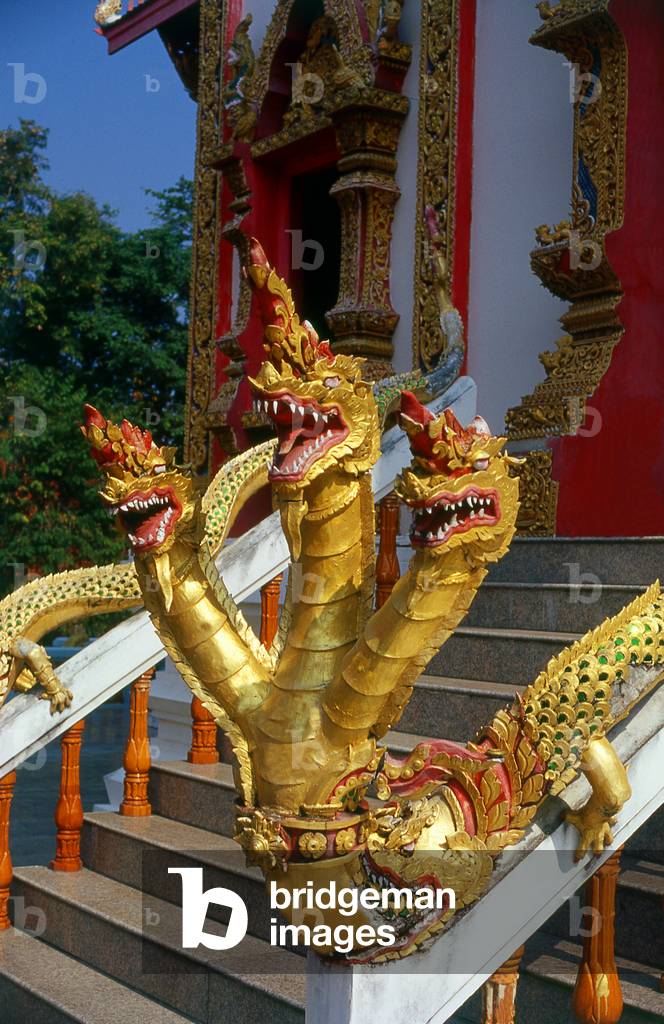 Thailand: A three-headed naga (mythical snake) emerges from the mouth of a makara (mythical sea creature), balustrade leading into the main viharn at Wat Phrathat Doi Saket, Chiang Mai, northern Thailand