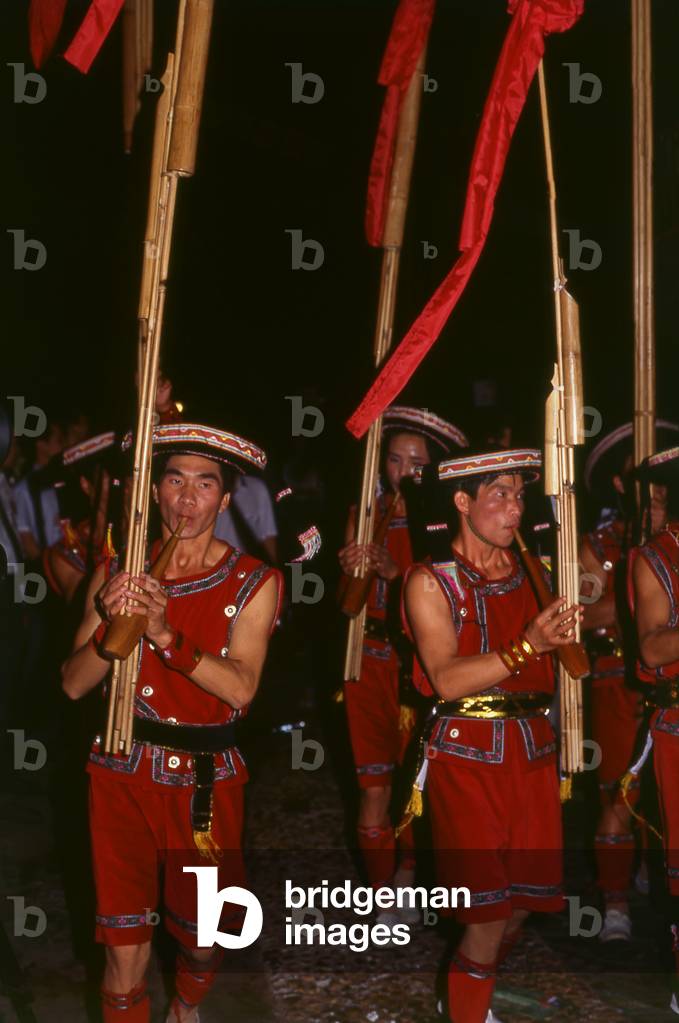 China: Miao men playing large lusheng, a traditonal Miao instrument, at a festival near Guiyang, Guizhou