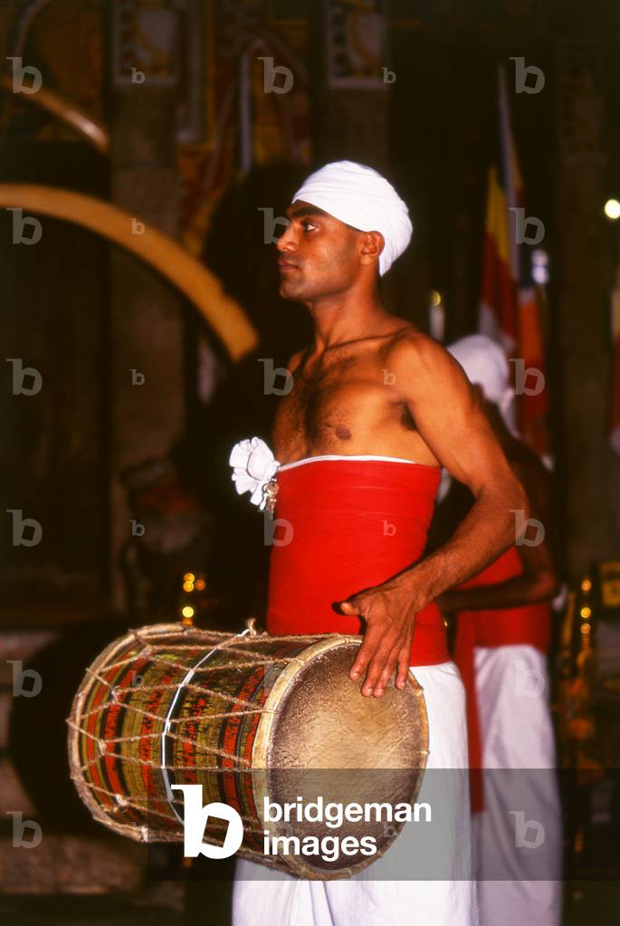 Sri Lanka: Drummer during the evening <i>puja</i> (worship and oferings time) at the Temple of the Tooth, Kandy