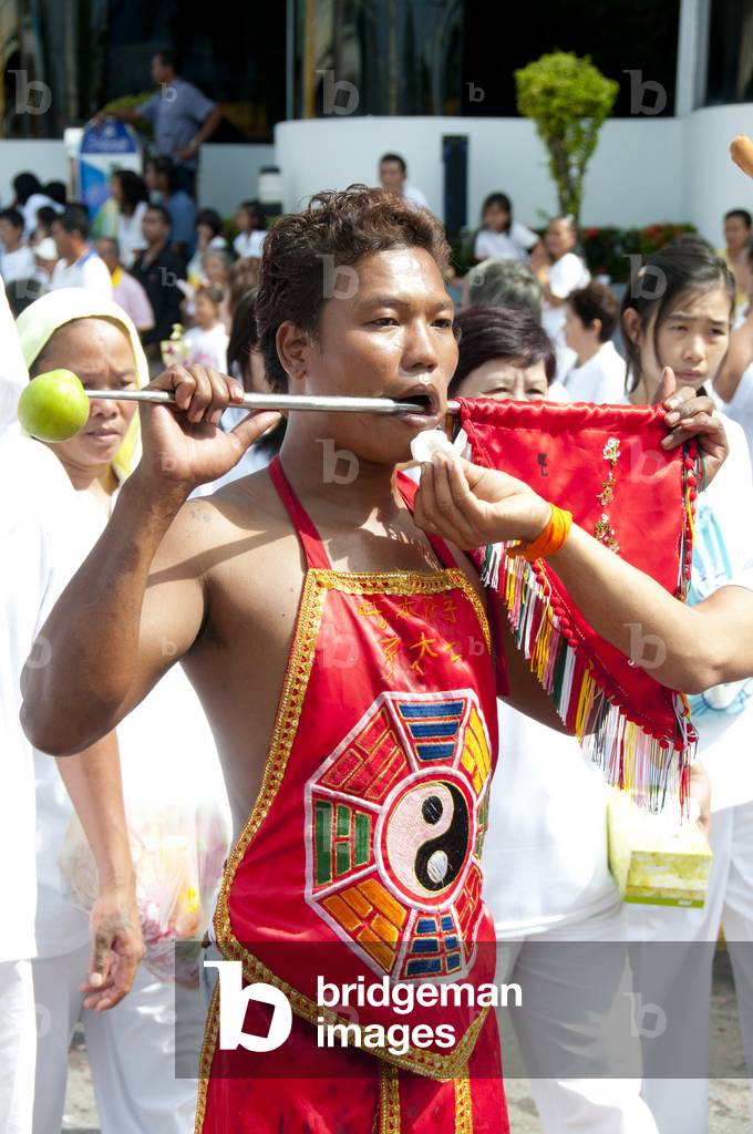 Thailand: An attendant wipes the mouth of a 'Ma Song' (entranced devotee), Phuket Vegetarian Festival