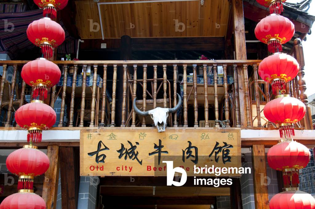 China: Restaurant sign displaying both Naxi (Dongba) and Chinese script, Lijiang Old Town, Yunnan Province