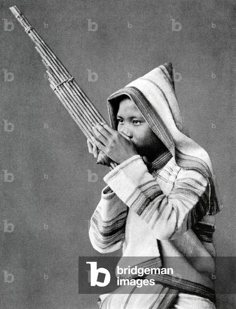 Thailand: An ethnic Karen from northern Thailand playing a 'khaen', or Lao flute, c. 1900.