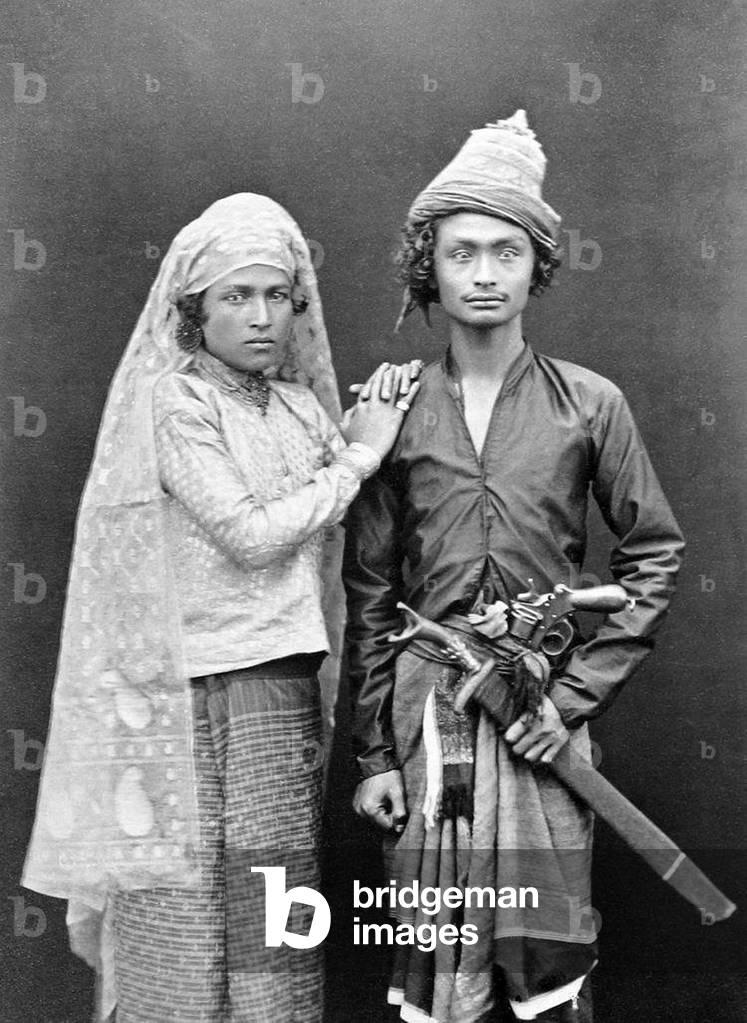 Indonesia / Sumatra: Armed Acehnese man posing with his wife, Banda Aceh, c. 1900. Aceh War (1873 - 1914)