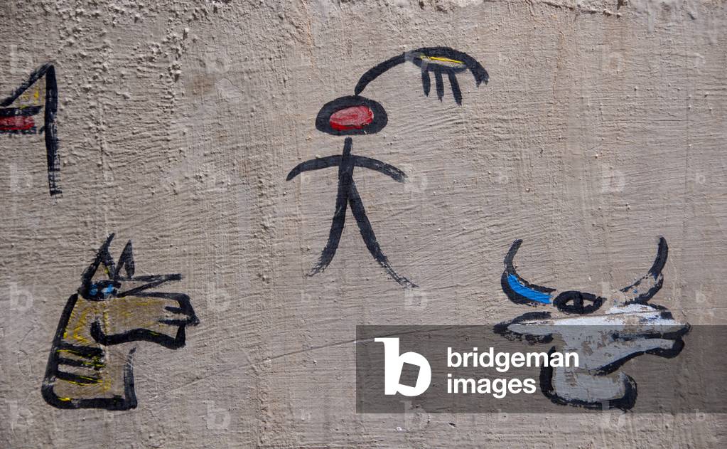 China: Dongba (Naxi) pictographic script on a house wall, Lijiang Old Town, Yunnan Province