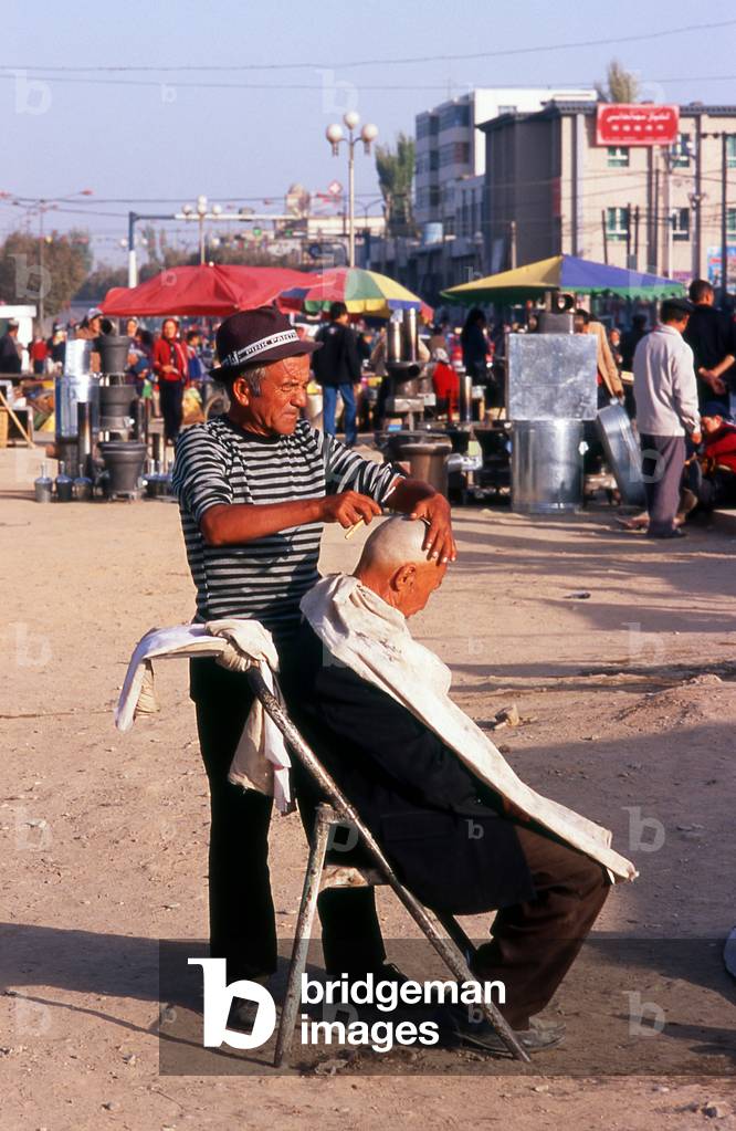 China: Outdoor barber, Old Kuqa, Xinjiang Province