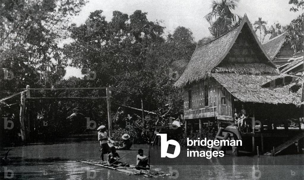 Thailand: A traditional Siamese house on stilts on a canal in Bangkok Noi, c. 1900