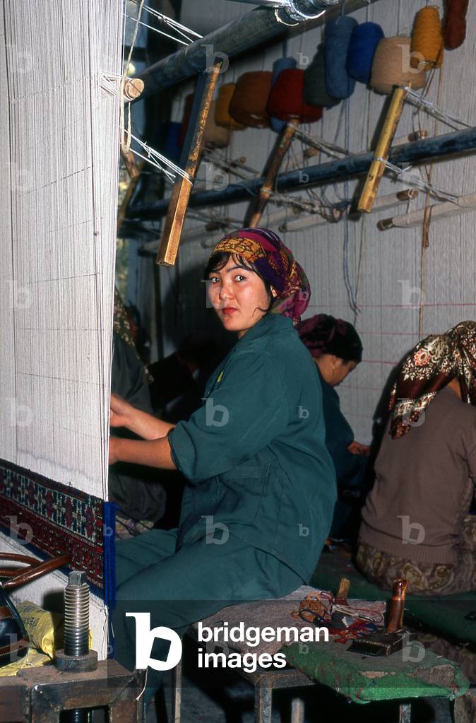 China: Uighur carpet weavers, carpet factory, Khotan, Xinjiang