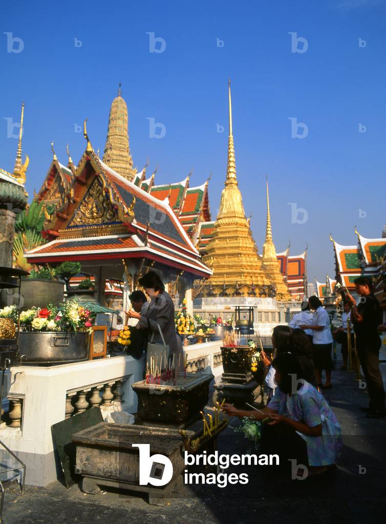 Thailand: People lighting incense at the Chao Mae Guan Im (Guanyin) shrine in front of the ubosot, Wat Phra Kaew (Temple of the Emerald Buddha), Bangkok