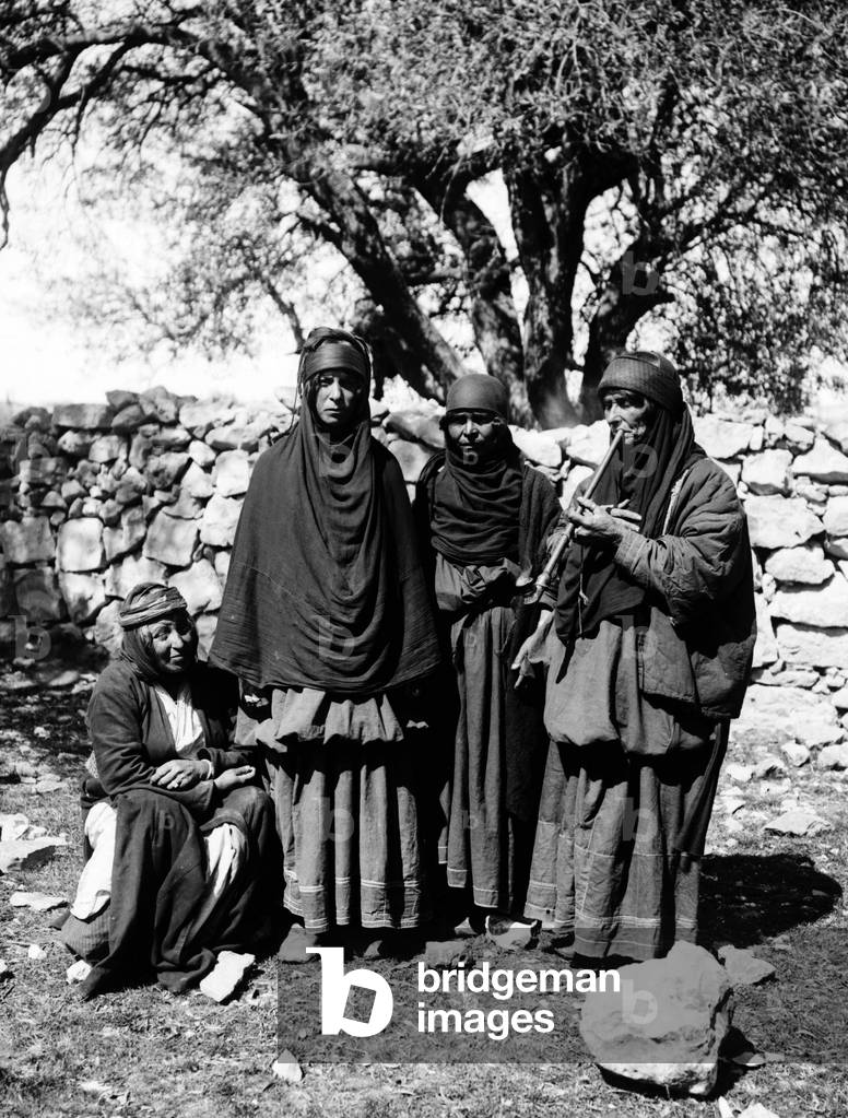 Jordan: A group of Bedouin women, one smoking a pipe, c. 1910