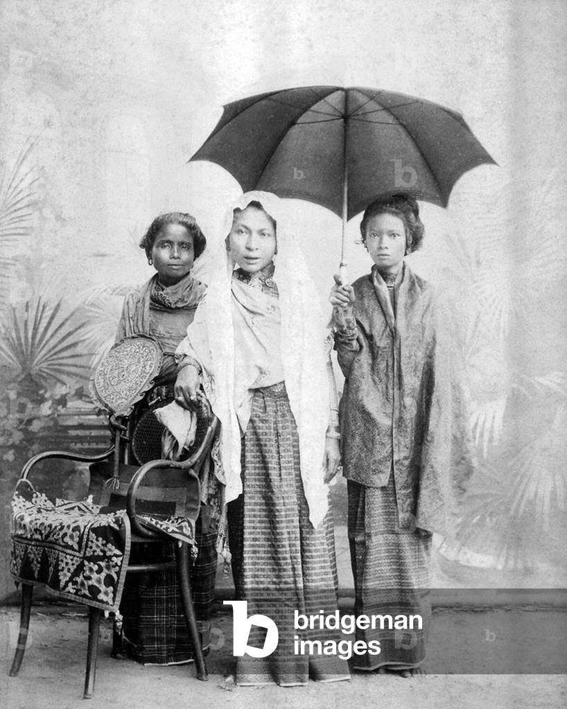 Indonesia / Sumatra: The wife of Alauddin Muhammad Da'ud Syah II, 35th and last Sultan of Aceh (centre) with two attendants. Banda Aceh, 1874