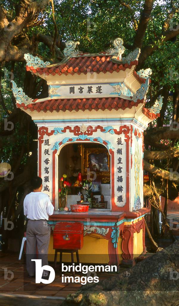 Vietnam: Small shrine with worshipper, Tay Ho Pagoda, West Lake (Ho Tay), Hanoi