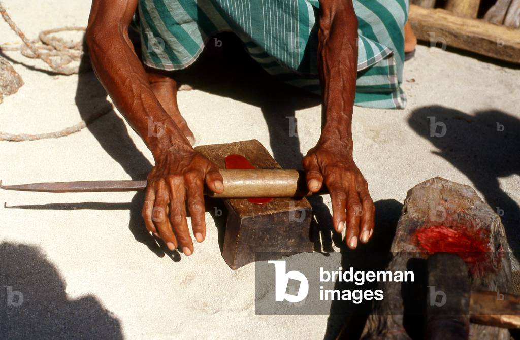Maldives: Lacquer workers preparing lacquer, Thulhaadhoo Island, Baa Atoll. This is the only island in the Maldives doing lacquer work, 1980