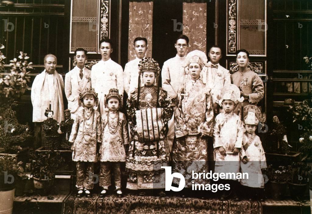 Malaysia / Singapore: A Peranakan bride and groom pose for their wedding photograph, Penang, c. 1920