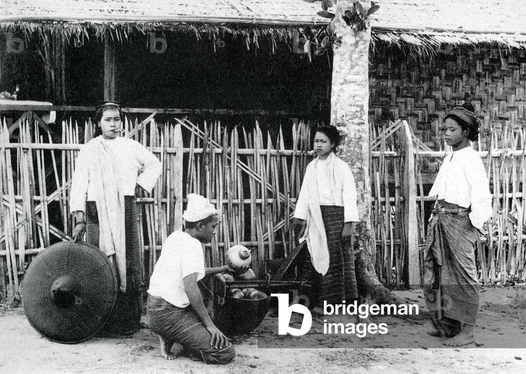 Burma / Myanmar: A woman smoking a cheroot sells calabashes in Mong Yawng in Shan State in 1929.