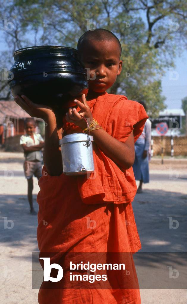 Burma / Myanmar: A young novice monk with alms bowl at Bagan (Pagan)