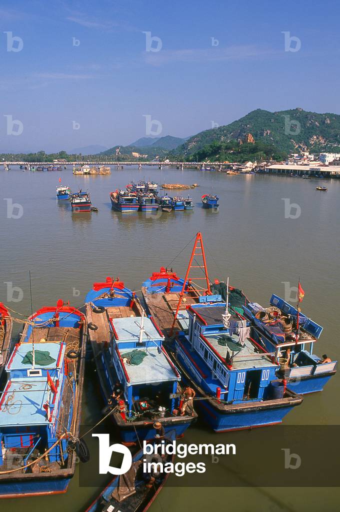 Vietnam: Fishing boats in the harbour, with the Po Nagar Cham Towers on the hill in the background, Nha Trang, Khanh Hoa Province