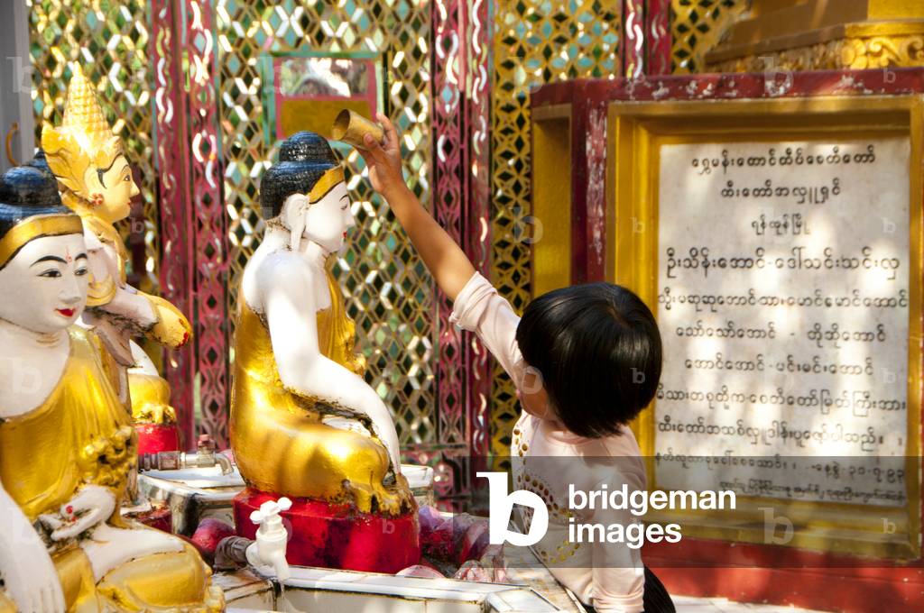Burma / Myanmar: Bathing Buddha statues with water (a merit making act) in the Sutaungpyei Pagoda at the summit of Mandalay Hill, Mandalay