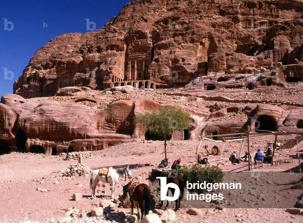 Jordan: Arab horsemen in front of The Urn Tomb, Petra