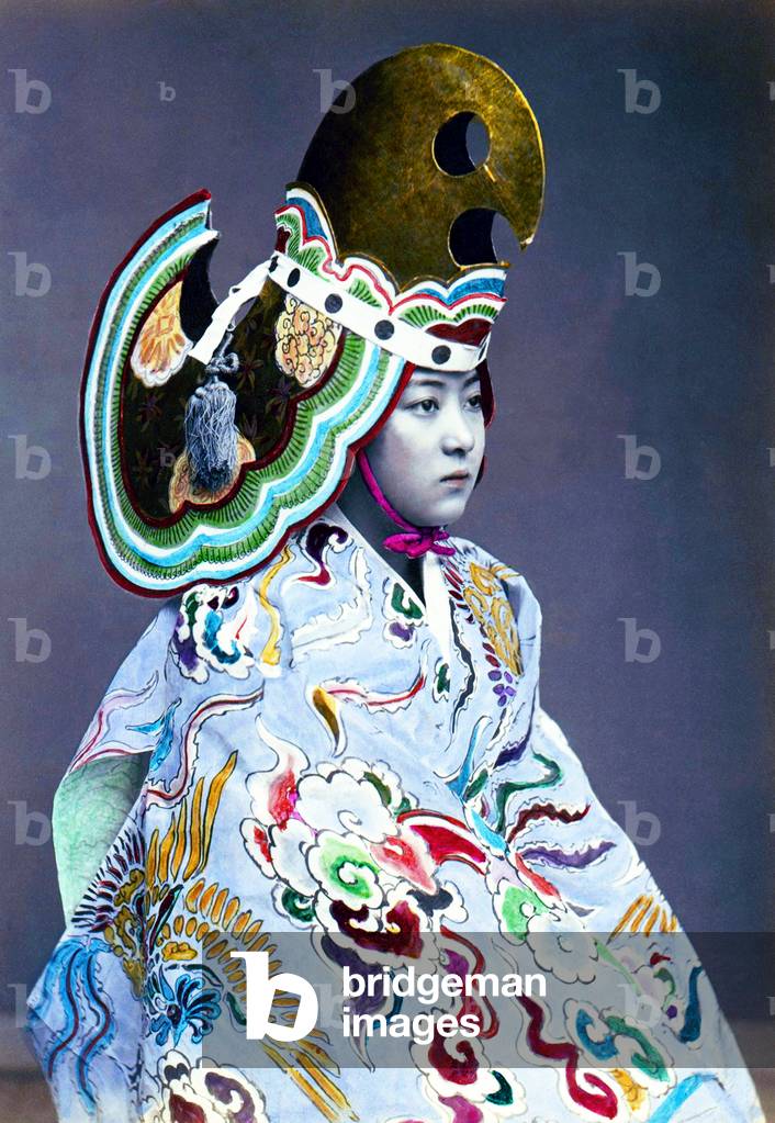 Japan: A young woman in Bugaku costume. Bugaku performers are always male, so this was certainly a studio photograph, hand-coloured albumen silver print, 1880s.