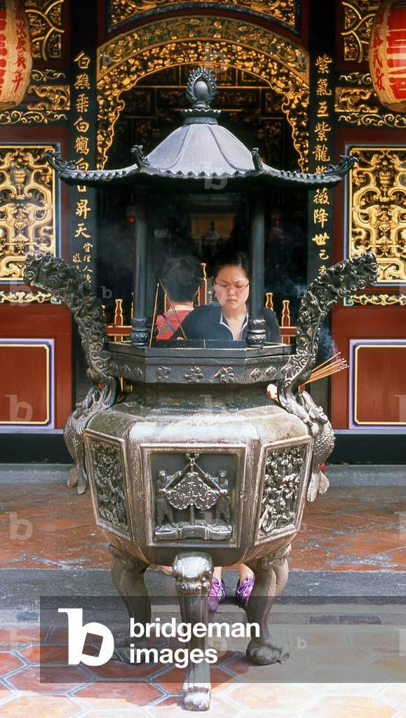 Taiwan: Lighting incense at an urn in the Dalongdong Baoan Temple, Taipei