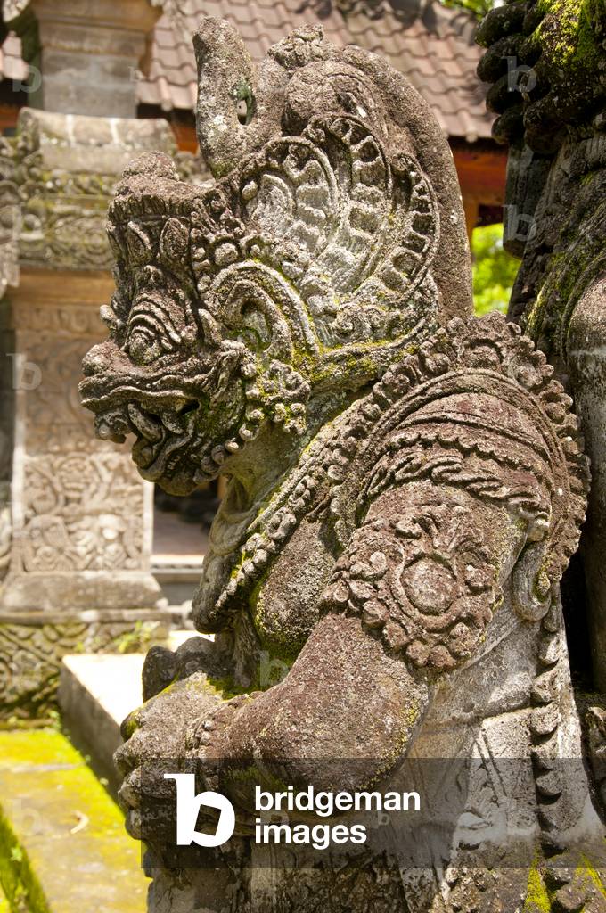 Indonesia: A stone figure from the Hindu epic Ramayana at the entrance to the 19th century Pura Meduwe Karang Hindu temple, Kubutambahan, northern Bali