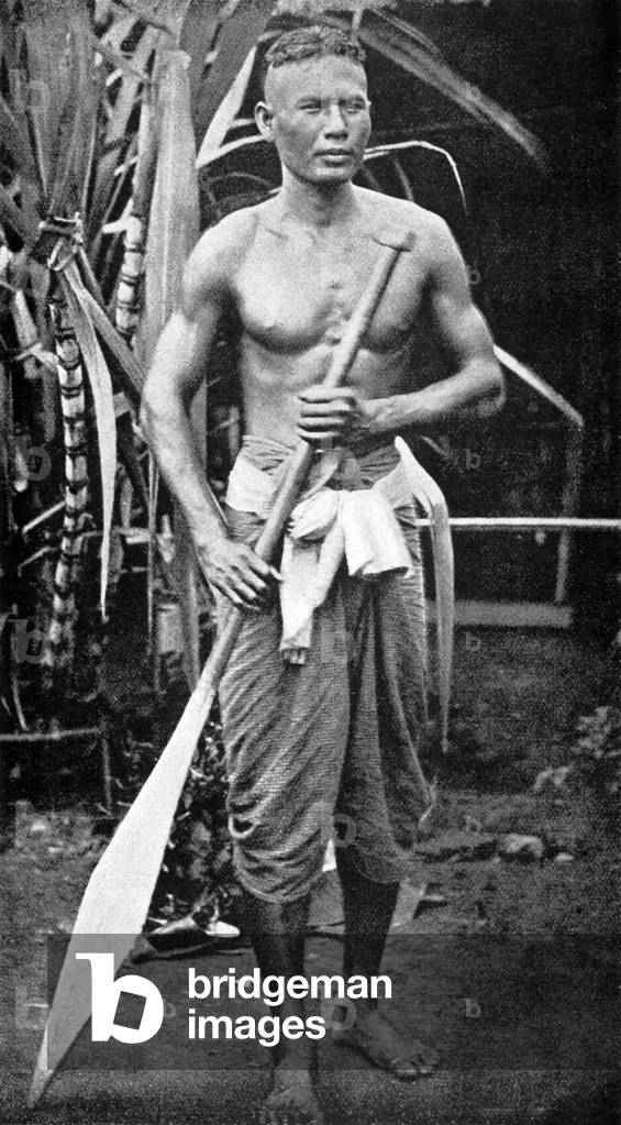 Thailand: An oarsman poses for a photograph in front of a sugar cane plant, Siam, mid-19th century.
