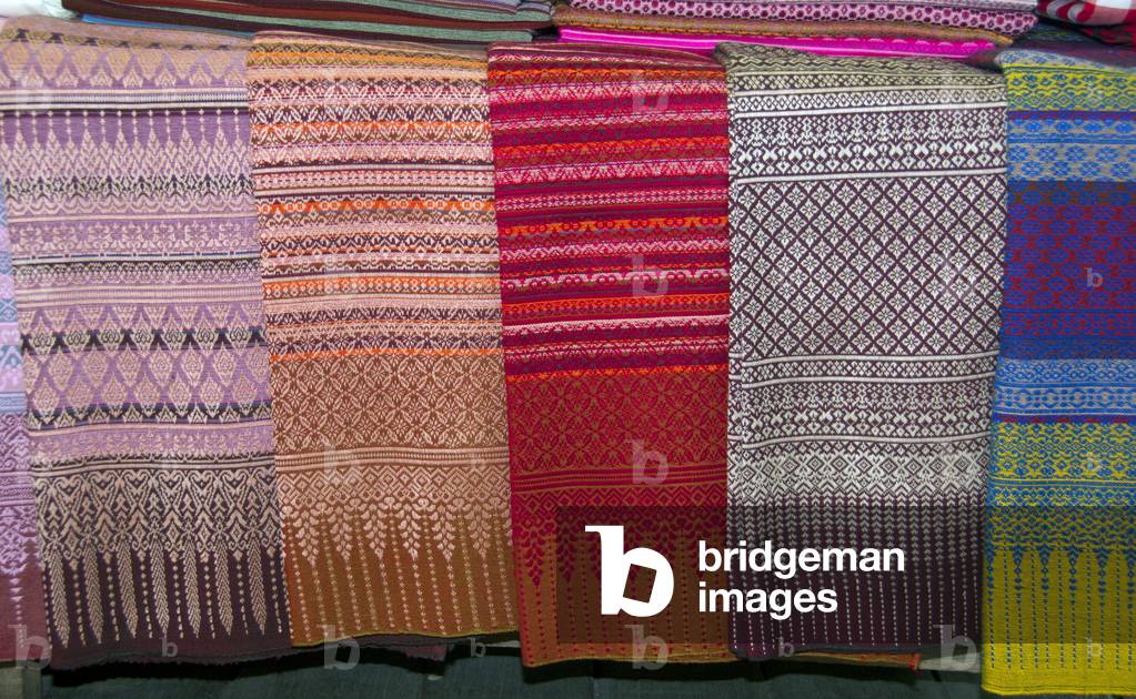 Thailand: Pha Mai Yok Dok silk fabrics for sale within the market on Lamphun's traditional covered wooden bridge near Wat Phra That Haripunchai, northern Thailand