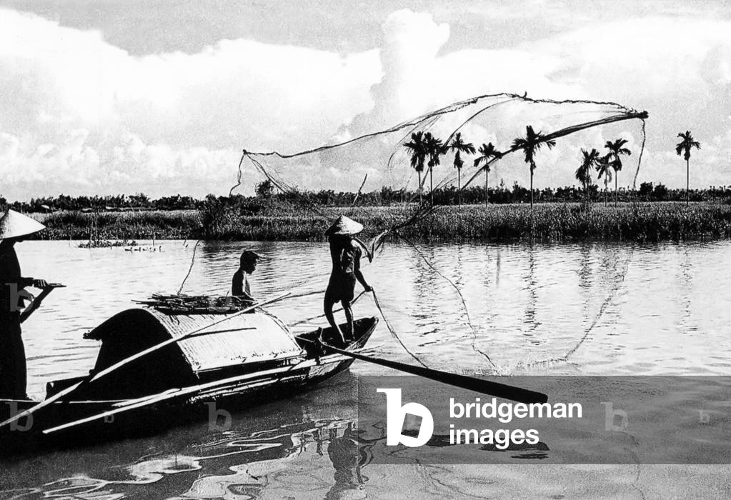 Vietnam: A fisherman casts his net on the Thu Bon River near Hoi An (1950)
