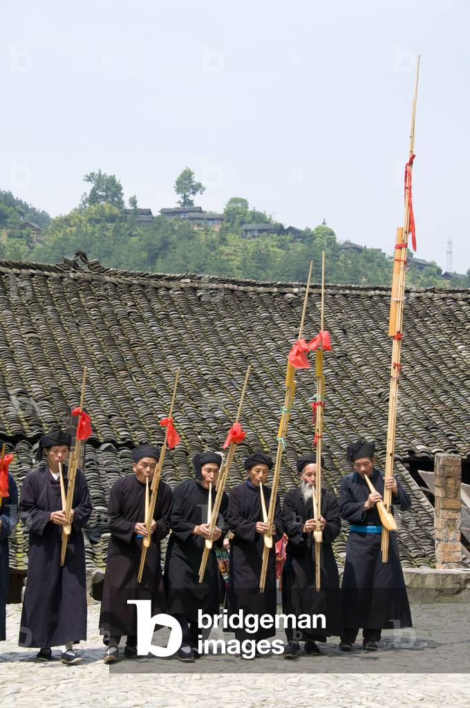 China: Miao men playing the lusheng, a traditonal Miao instrument, in the village of Langde Shang, southeast of Kaili, Guizhou Province