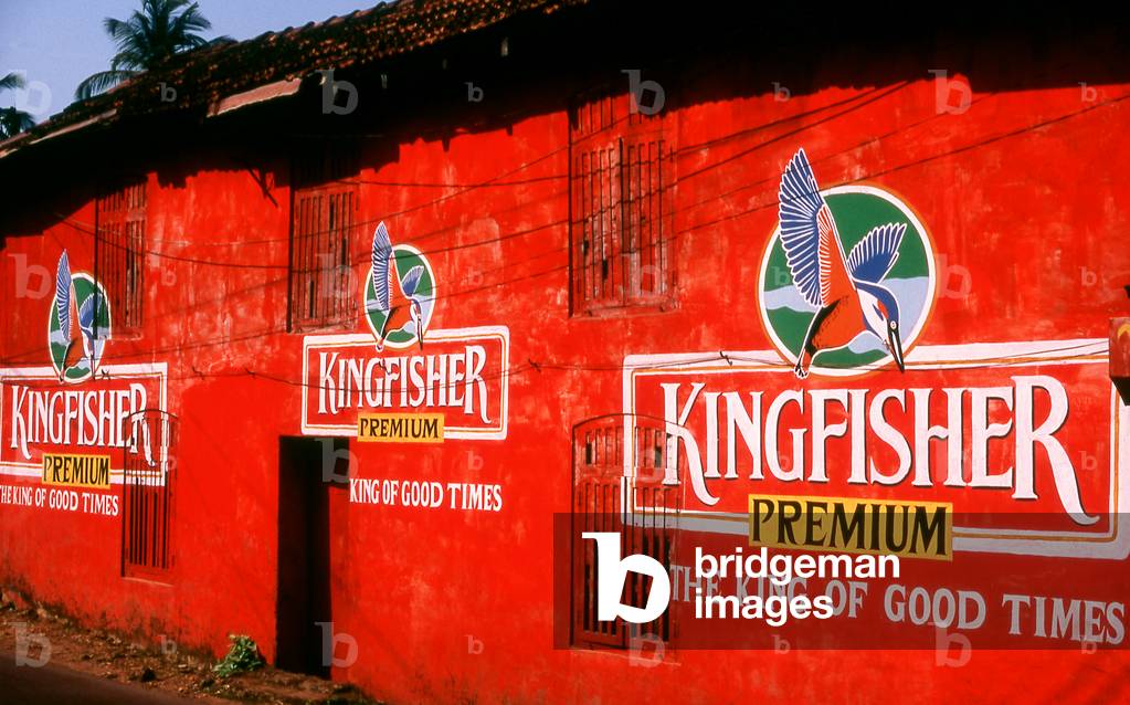 India: Kingfisher beer advertisements on the side of the brightly painted Vicente Pub on the road between Old Goa and Panjim, Goa