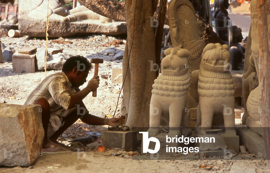 India: Stone worker at Dakshinchitra, near Mahabalipuram, Tamil Nadu