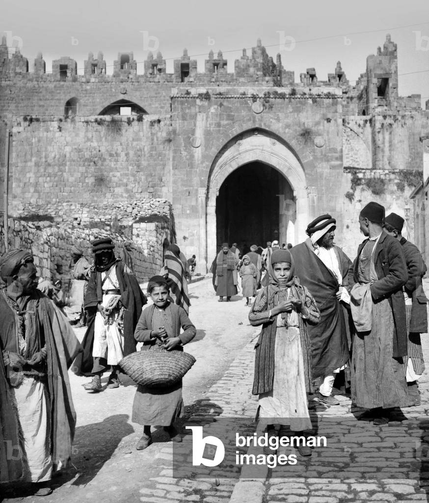 Palestine: Palestinians walking and talking outside the Damascus Gate, Jerusalem, c. 1910