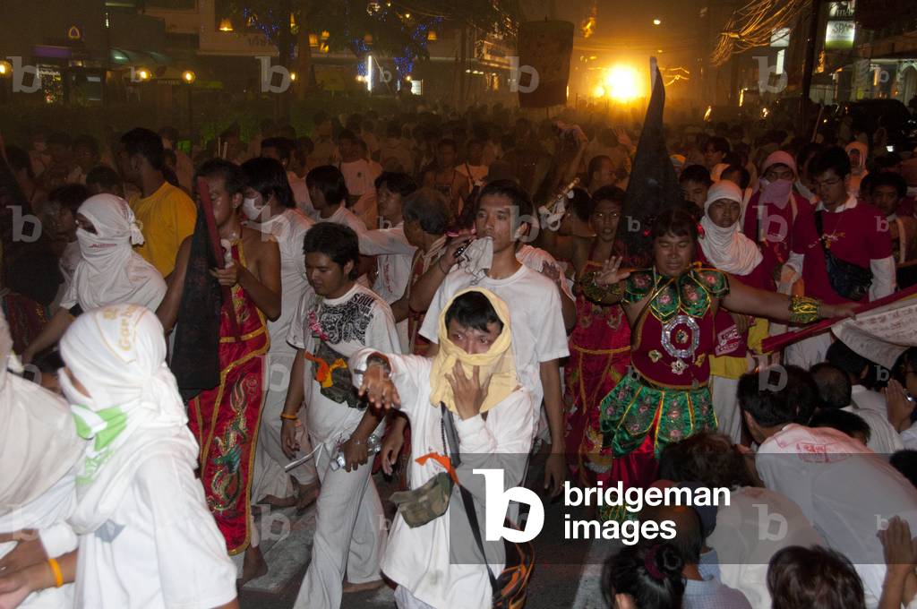 Thailand: Devotees in the night parade pass through the streets of Phuket Town, Phuket Vegetarian Festival