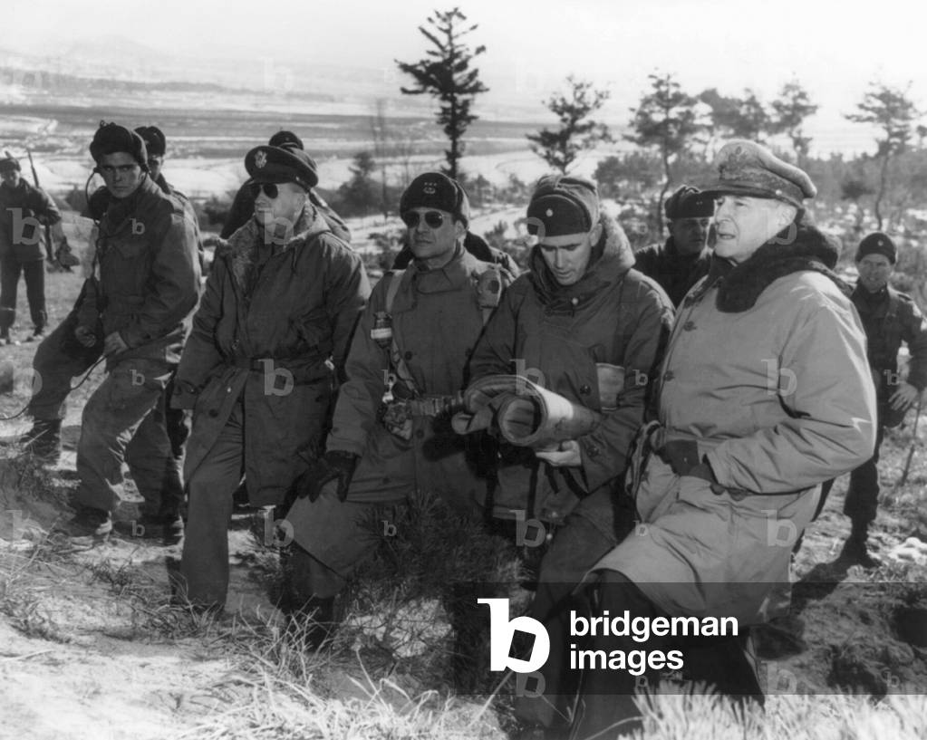 Korea: General Douglas MacArthur at the front line above Suwon, Korea, accompanied by Courtney Whitney, Matthew B. Ridgway, William B. Kean, and others, January 28, 1951