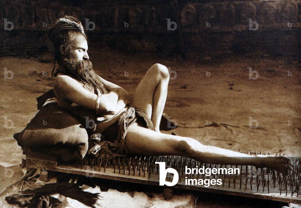 India: A Hindu sannyasi resting on a bed of nails, Varanasi, 1907 (photo)