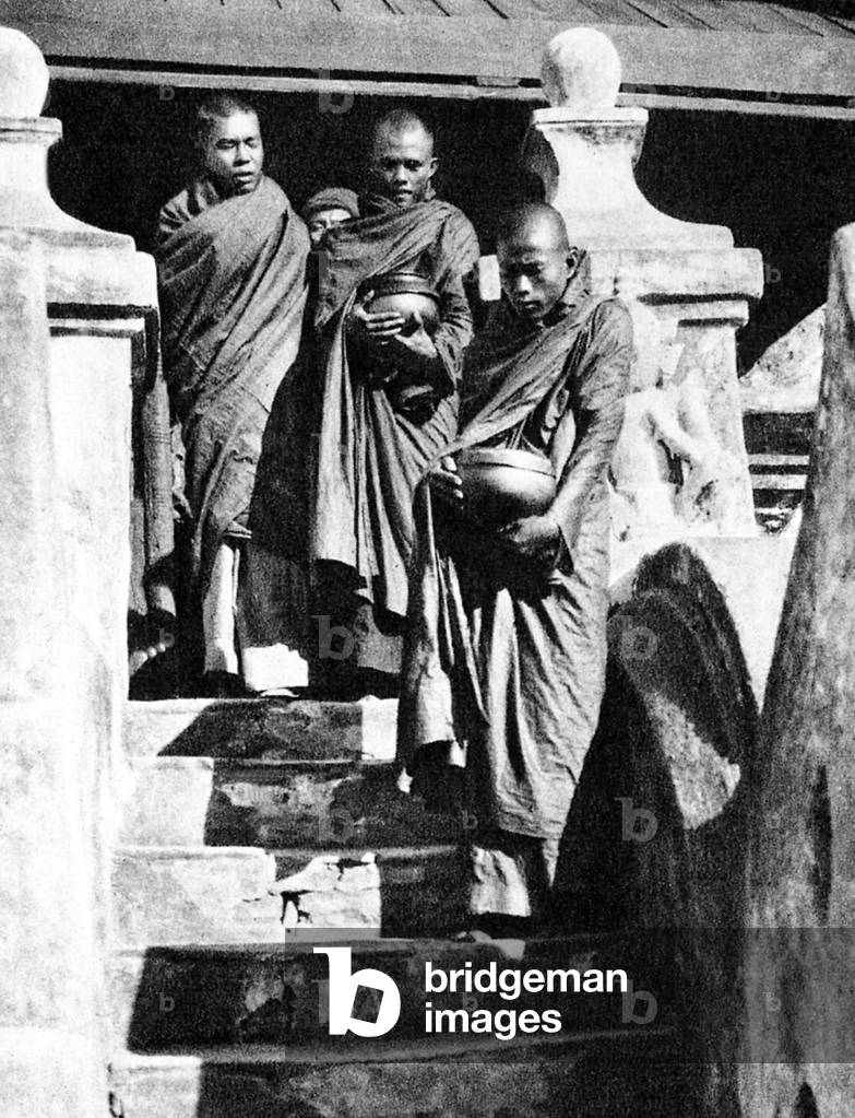 Burma/ Myanmar: Buddhist monks leave their monastery early in the morning to collect alms, c.1920s.