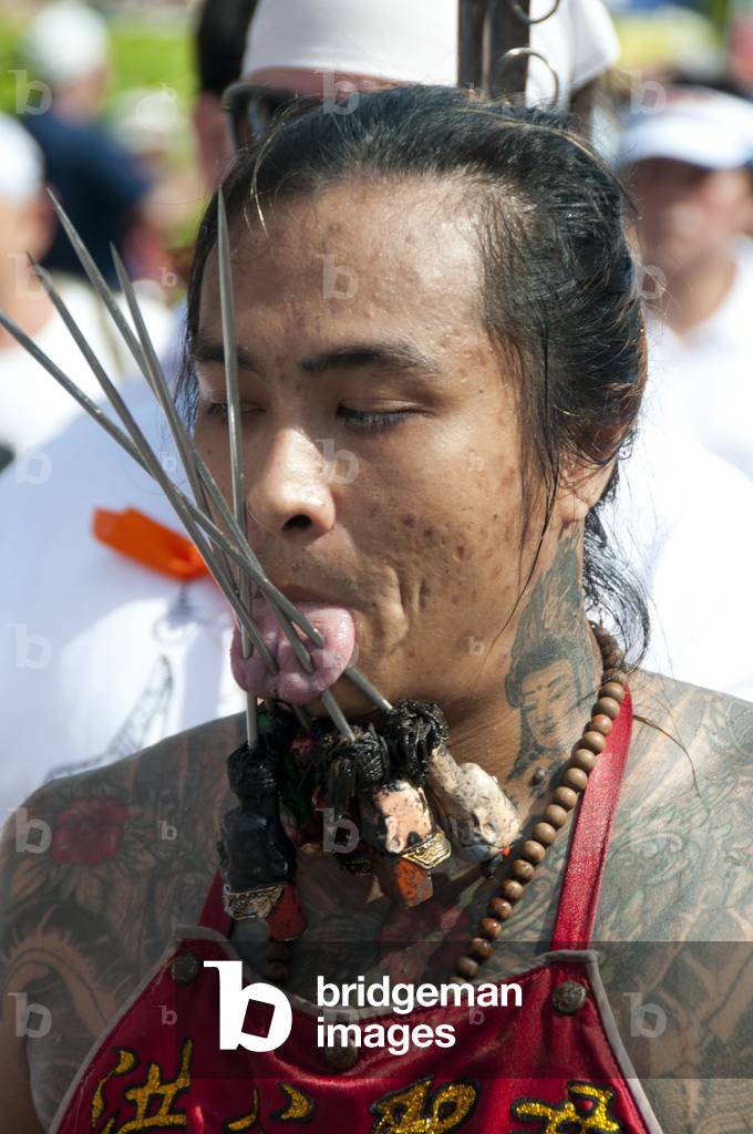 Thailand: Entranced devotee or 'Ma Song' takes part in a procession through Phuket Town, Phuket Vegetarian Festival