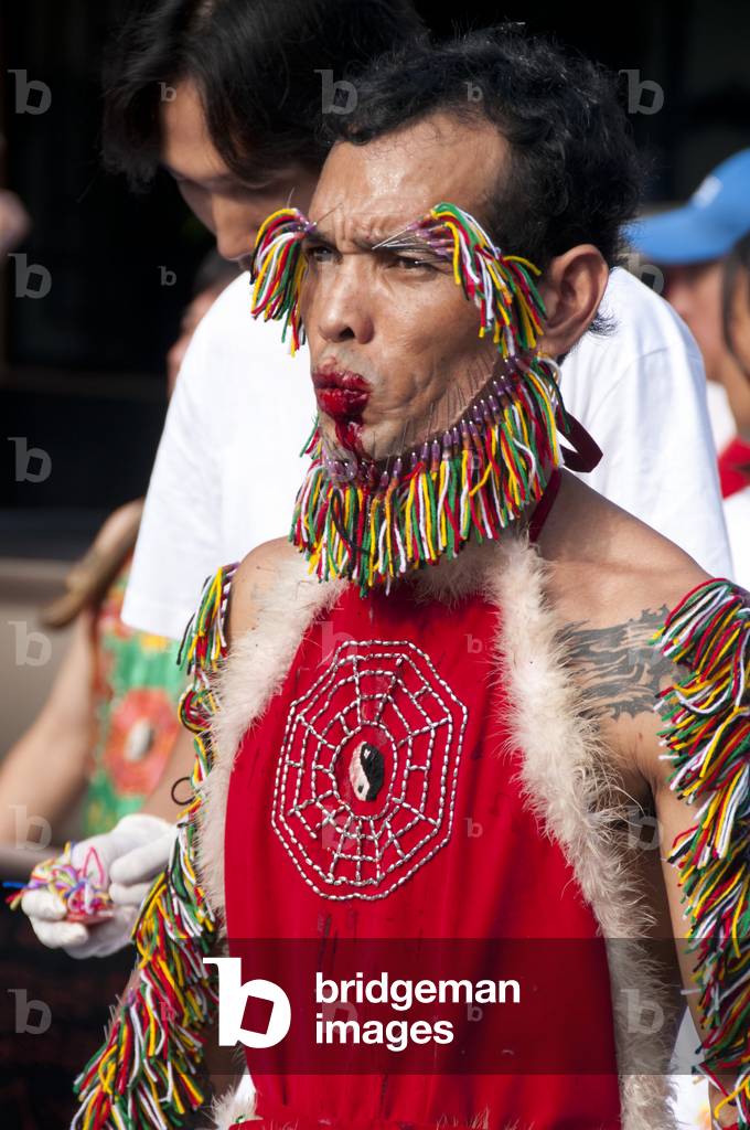 Thailand: Entranced devotee or 'Ma Song' takes part in a procession through Phuket Town, Phuket Vegetarian Festival