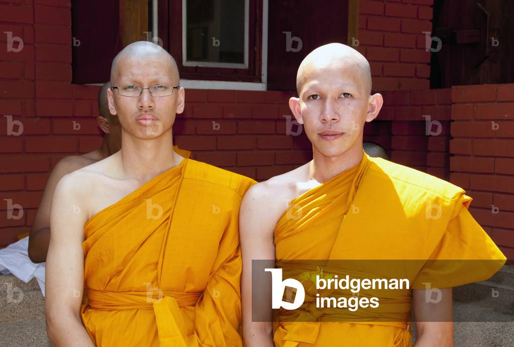 Thailand: Thai Buddhist ordination ceremony, Wat Rampoeng, Chiang Mai. The newly ordained monk is shown how to tie his first robe