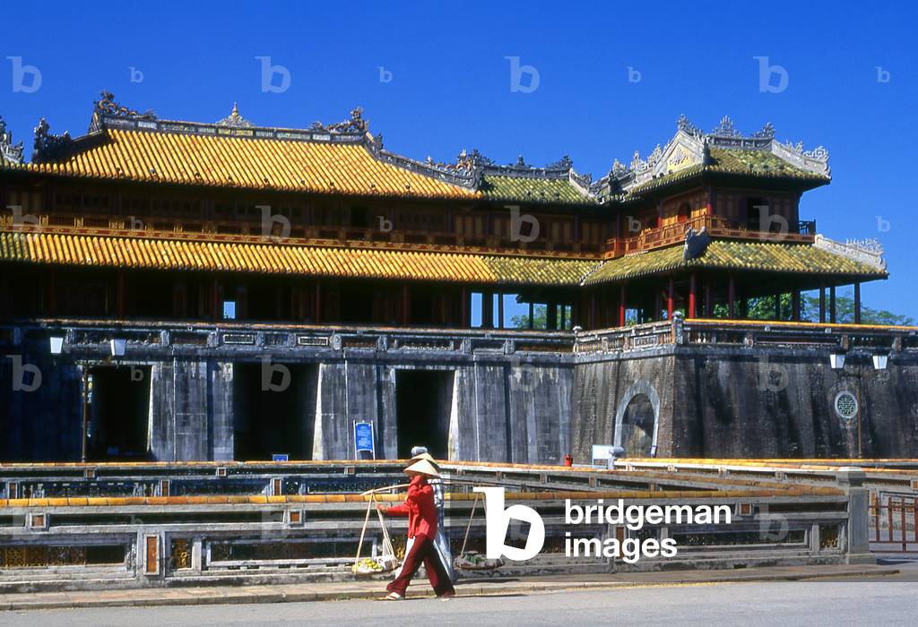Vietnam: A fruit vendor passes the Ngo Mon Gate, The Imperial City, The Citadel, Hue