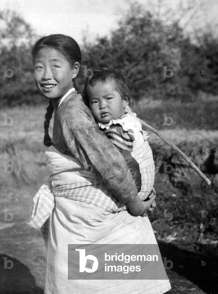 Korea: A girl carrying a child on her back, Heijo (Pyongyang), Korea, 1939