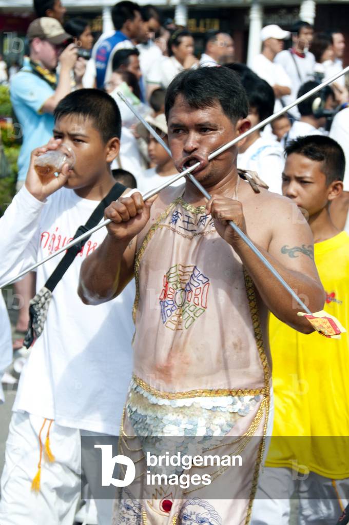 Thailand: Entranced devotee or 'Ma Song' takes part in a procession through Phuket Town, Phuket Vegetarian Festival