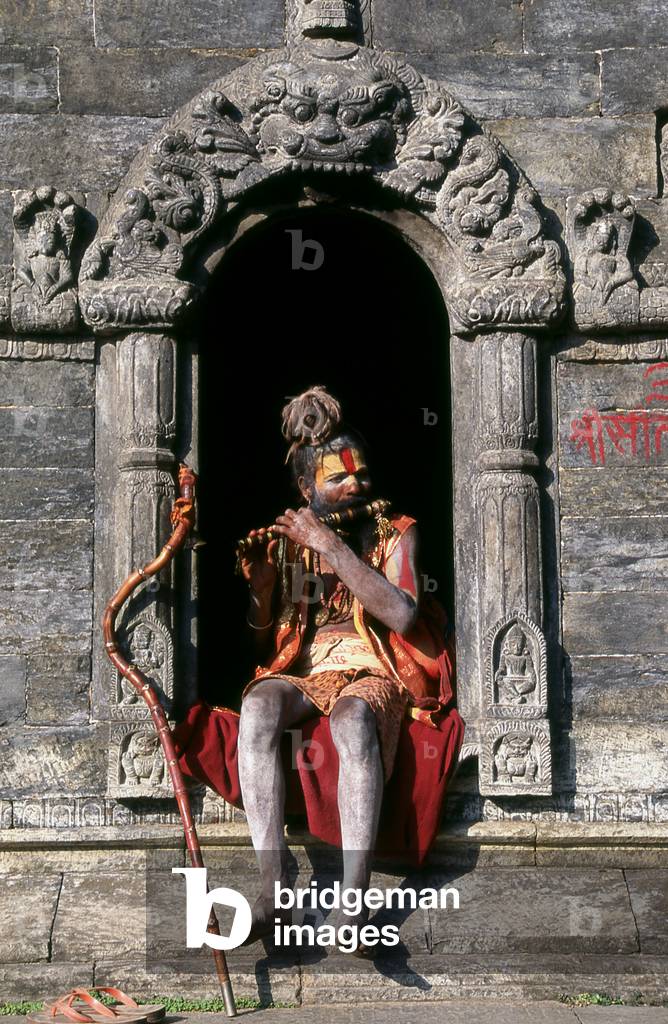 Nepal: Pipe (flute) playing sadhu, Pashupatinath, Kathmandu (photo)