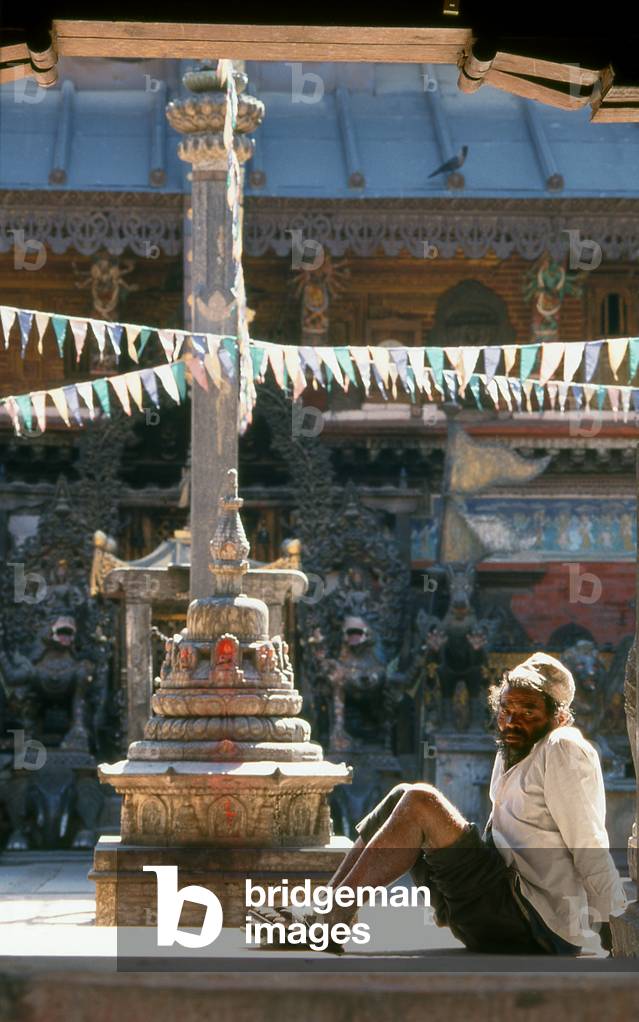 Nepal: A man sits in front of a chaitya (small Buddhist shrine) in the Rudra Varna Mahavihar temple, Patan, Kathmandu Valley (1998)