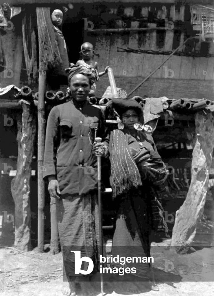 Indonesia: A Batak couple of northern Sumatra in traditional clothing, c. 1915.