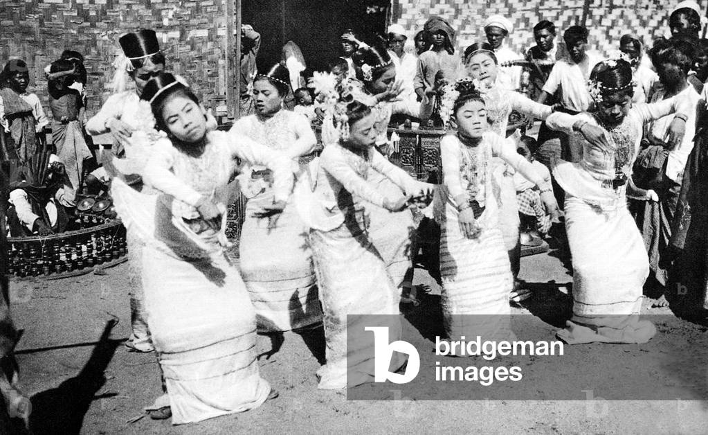 Burma/ Myanmar: A young Burmese ballet troupe performs in the street accompanied by a 'saingwaing' band, c.1920s.