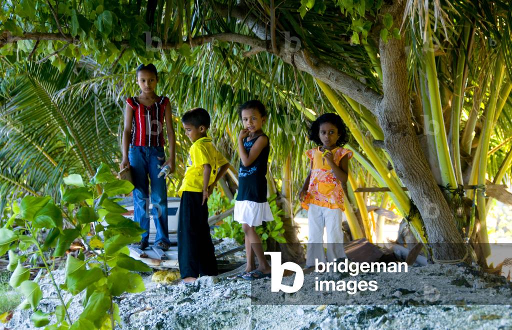 Maldives: Children on top of the man-made soil wall built for the protection of the local houses, Feydhoo Island, Addu Atoll (Seenu Atoll)