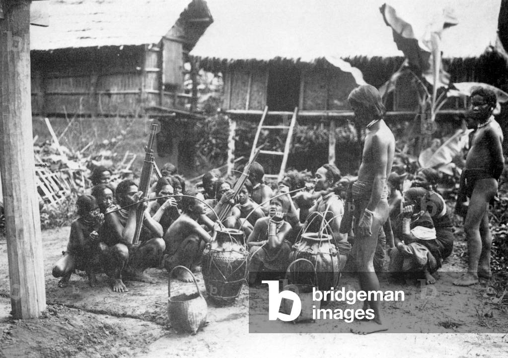 Laos: Ethnic Nyahuen villagers gather for a buffalo sacrifice ceremony in 1902.